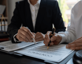 Image of two people looking at a contract.