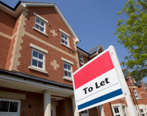 Image of a "to let" sign in front of a residential property.