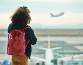 Image of a child looking out of an airport window.
